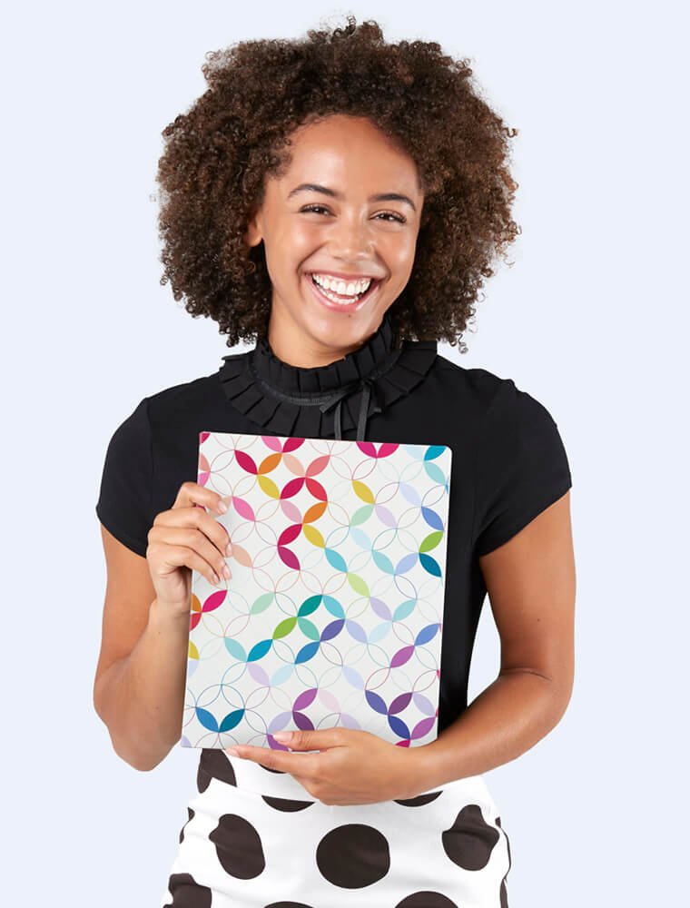 Woman holding Softbound Planners and looking at you.